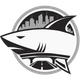 Stylized shark logo in black and white with a city skyline and road inside a circular emblem