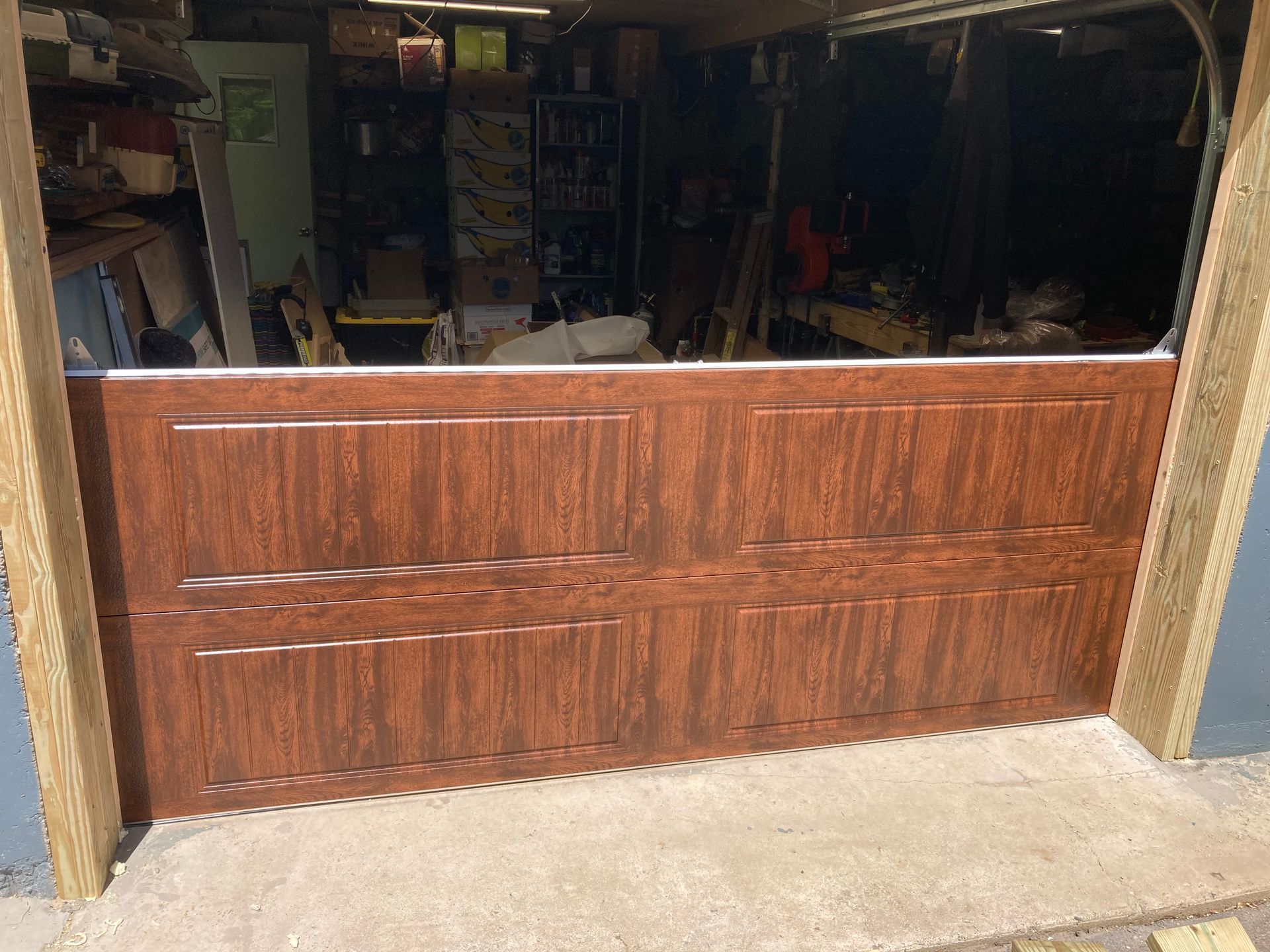 Wooden counter barrier across a dim workshop entrance, with shelves and tools visible inside.