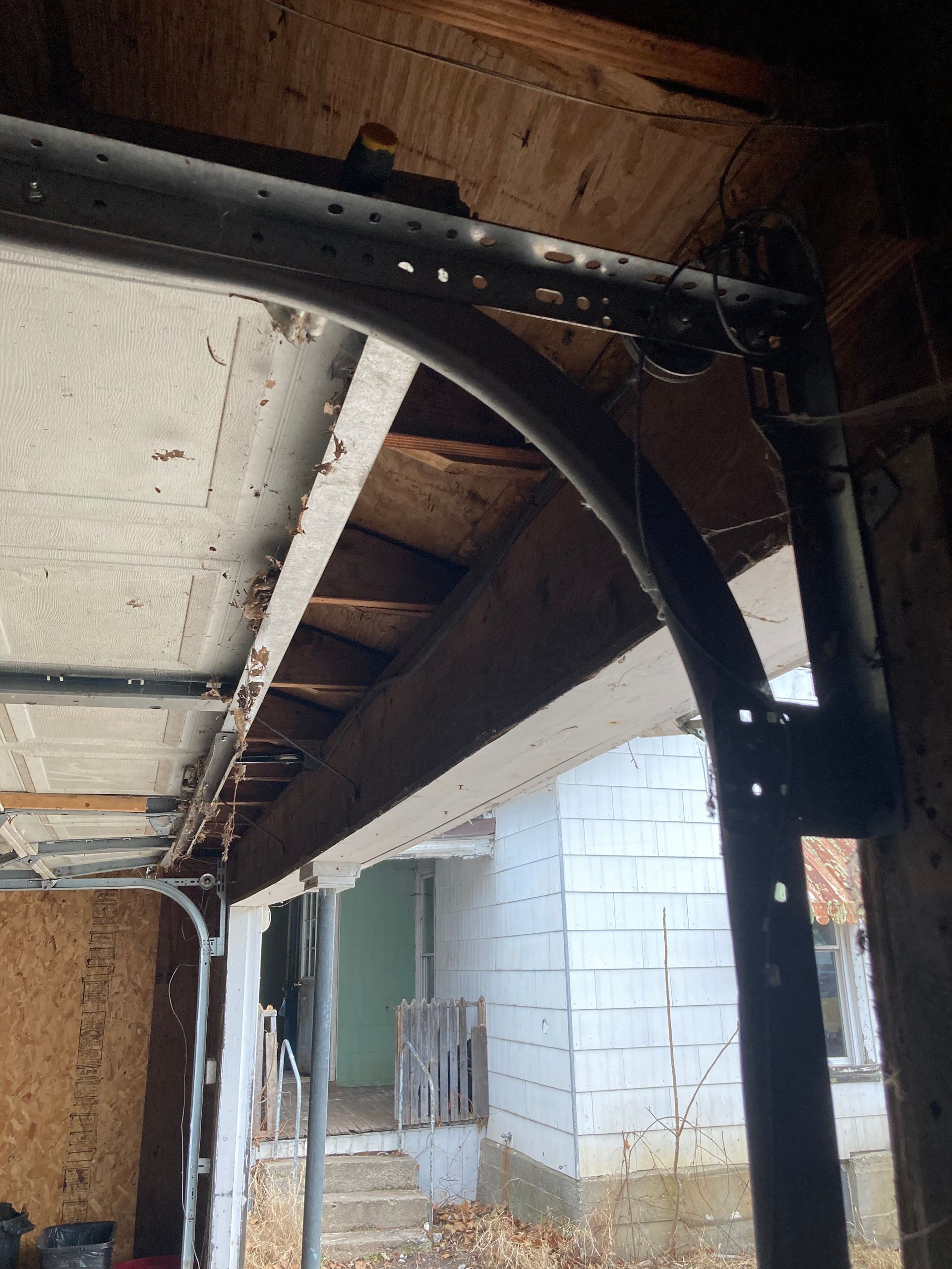 Partially finished covered porch with exposed beams, metal framing, and a white cinder block wall outside