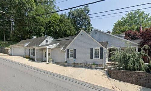A funeral home in Westminster, MD with a welcoming entrance and landscaped frontage sits along a quiet street