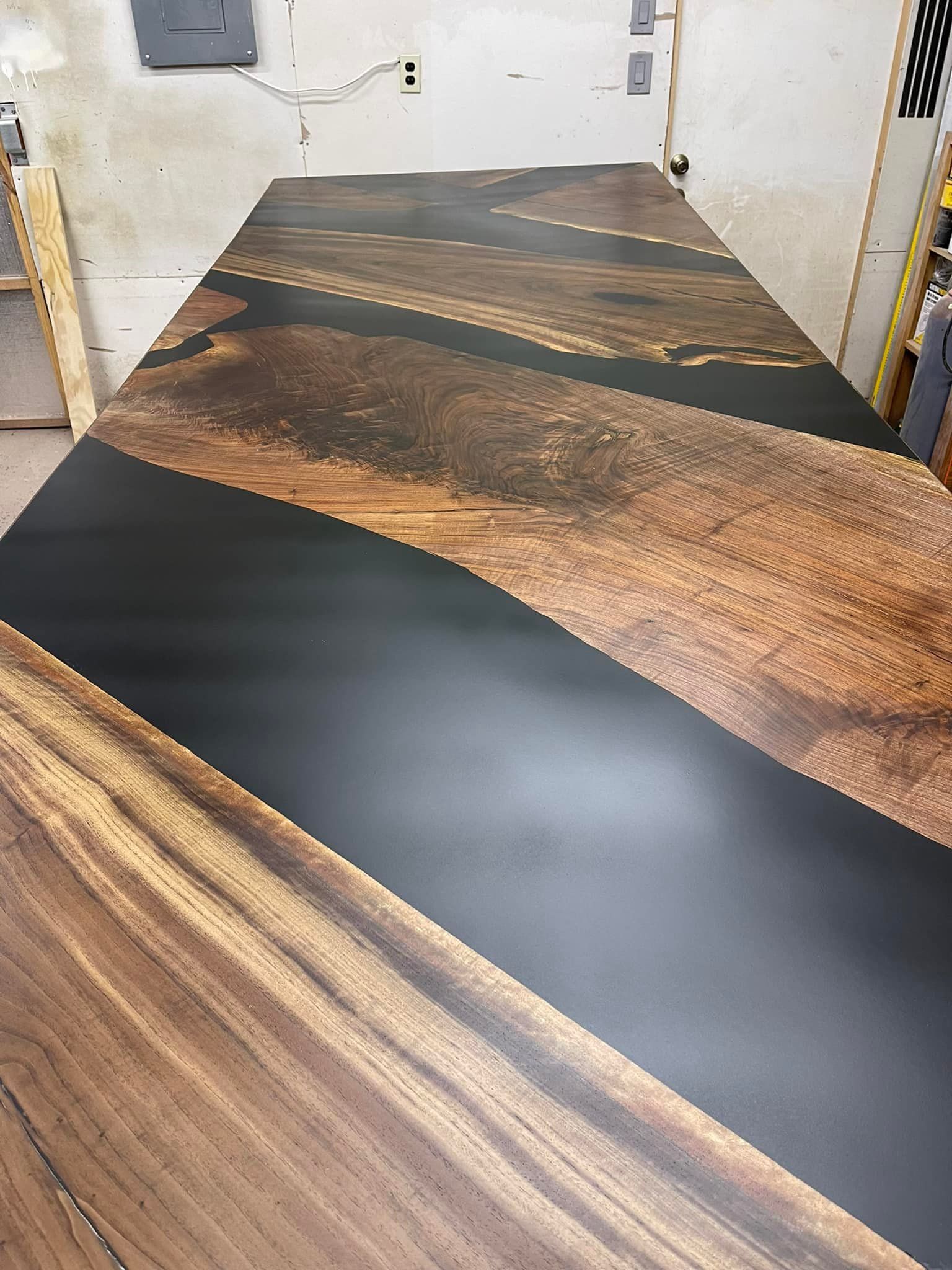 Wooden table with black resin river inlay.