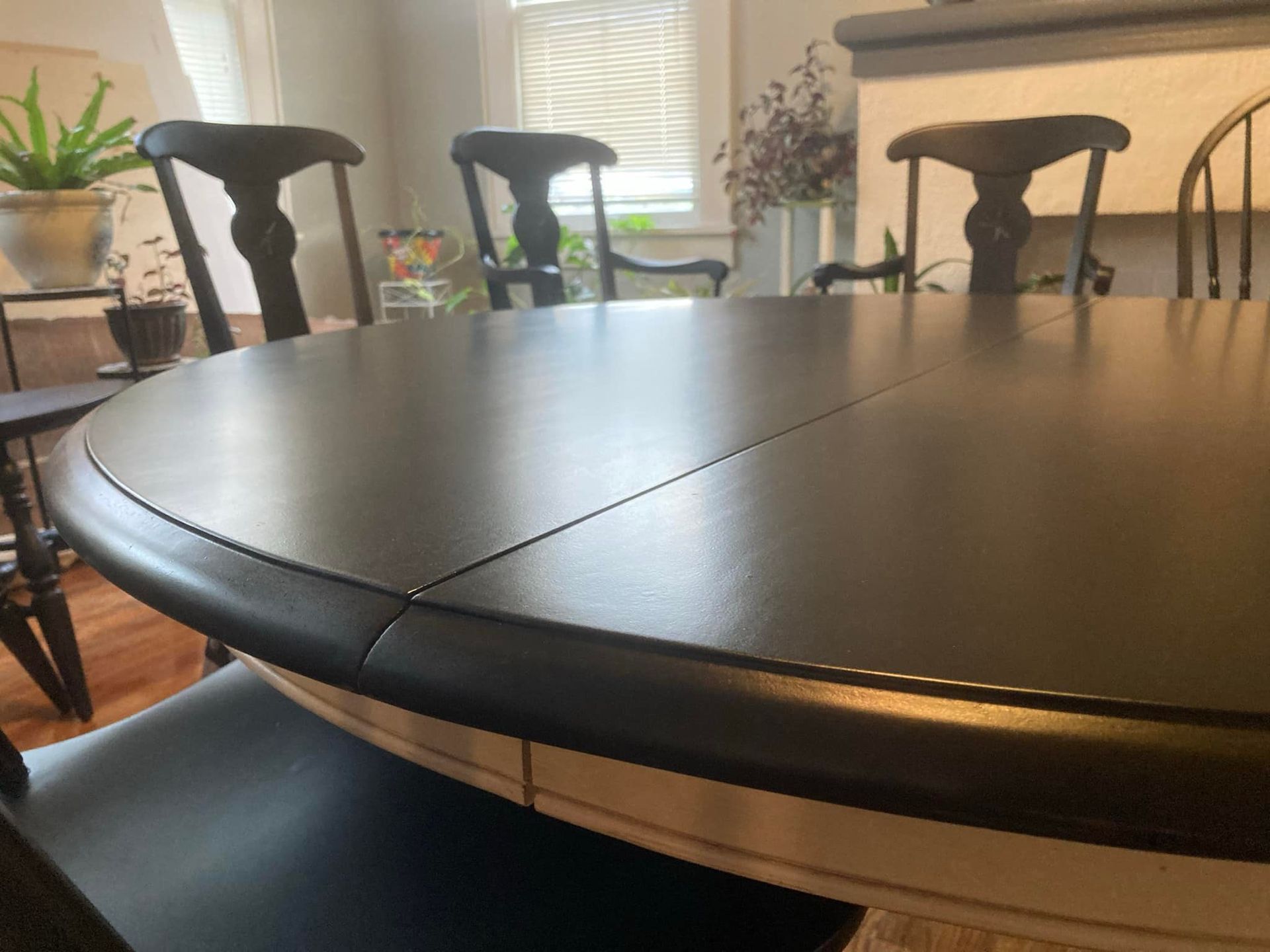 Black round dining table with chairs.