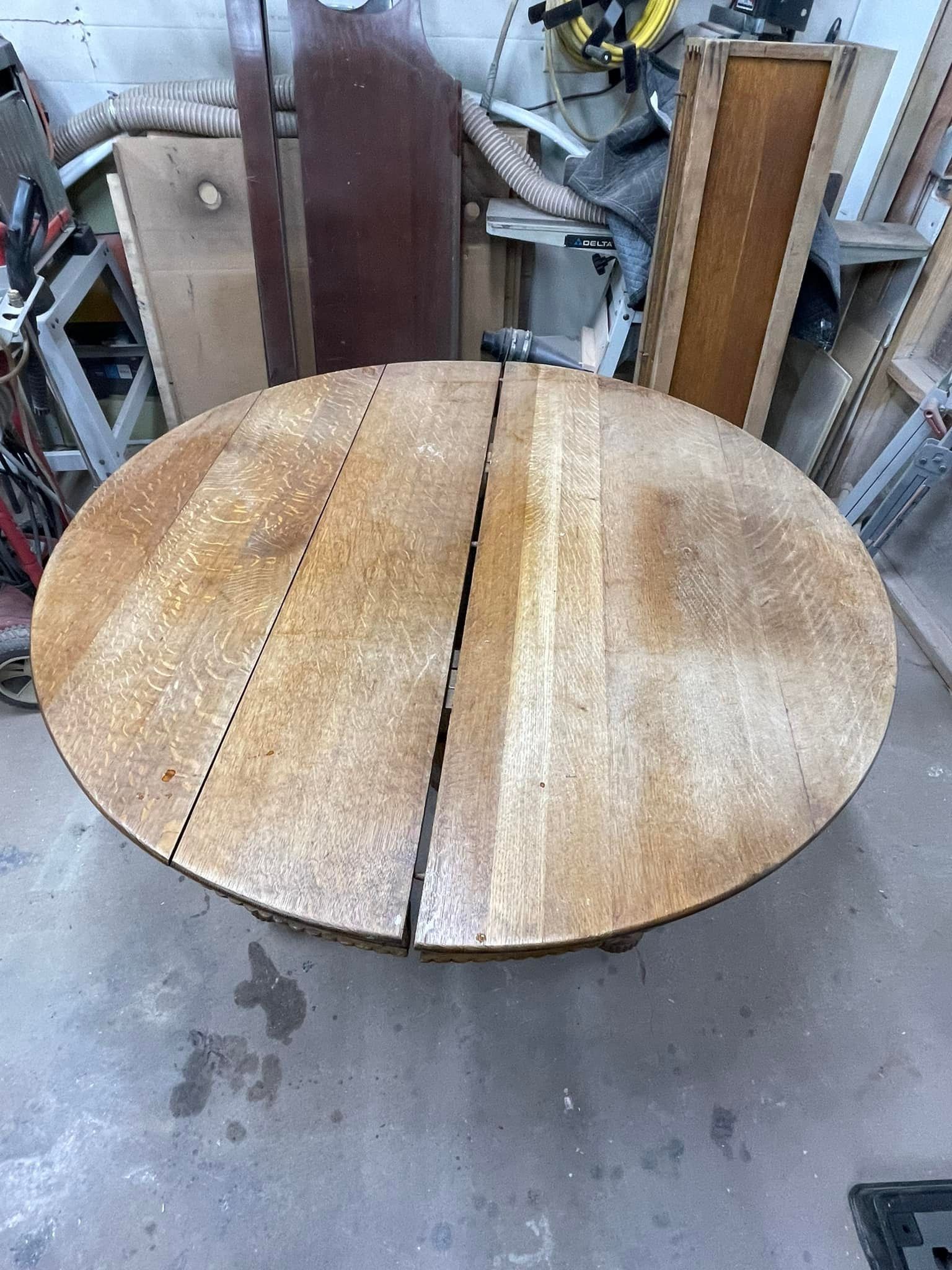 Round wooden table with center split, in a workshop setting.