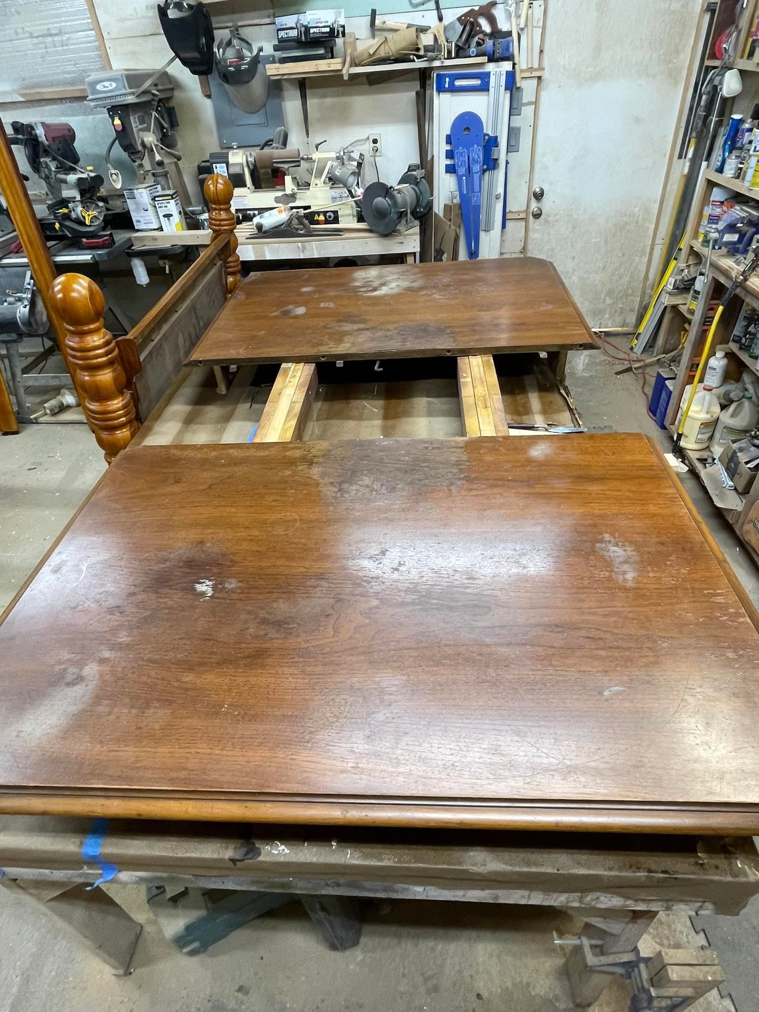 Bed frame with separated wooden panels, likely in a workshop.