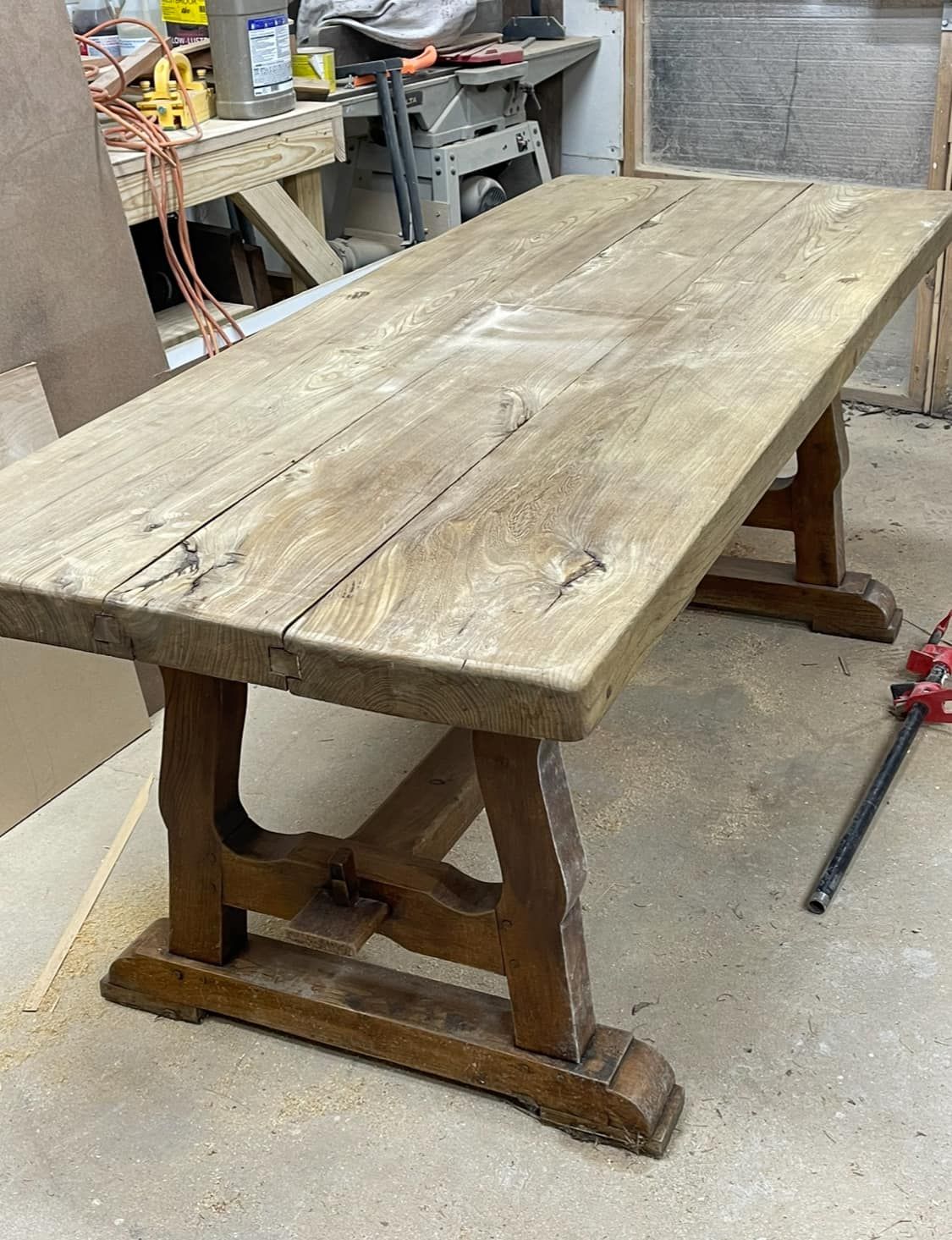 Wooden trestle table in a workshop setting.