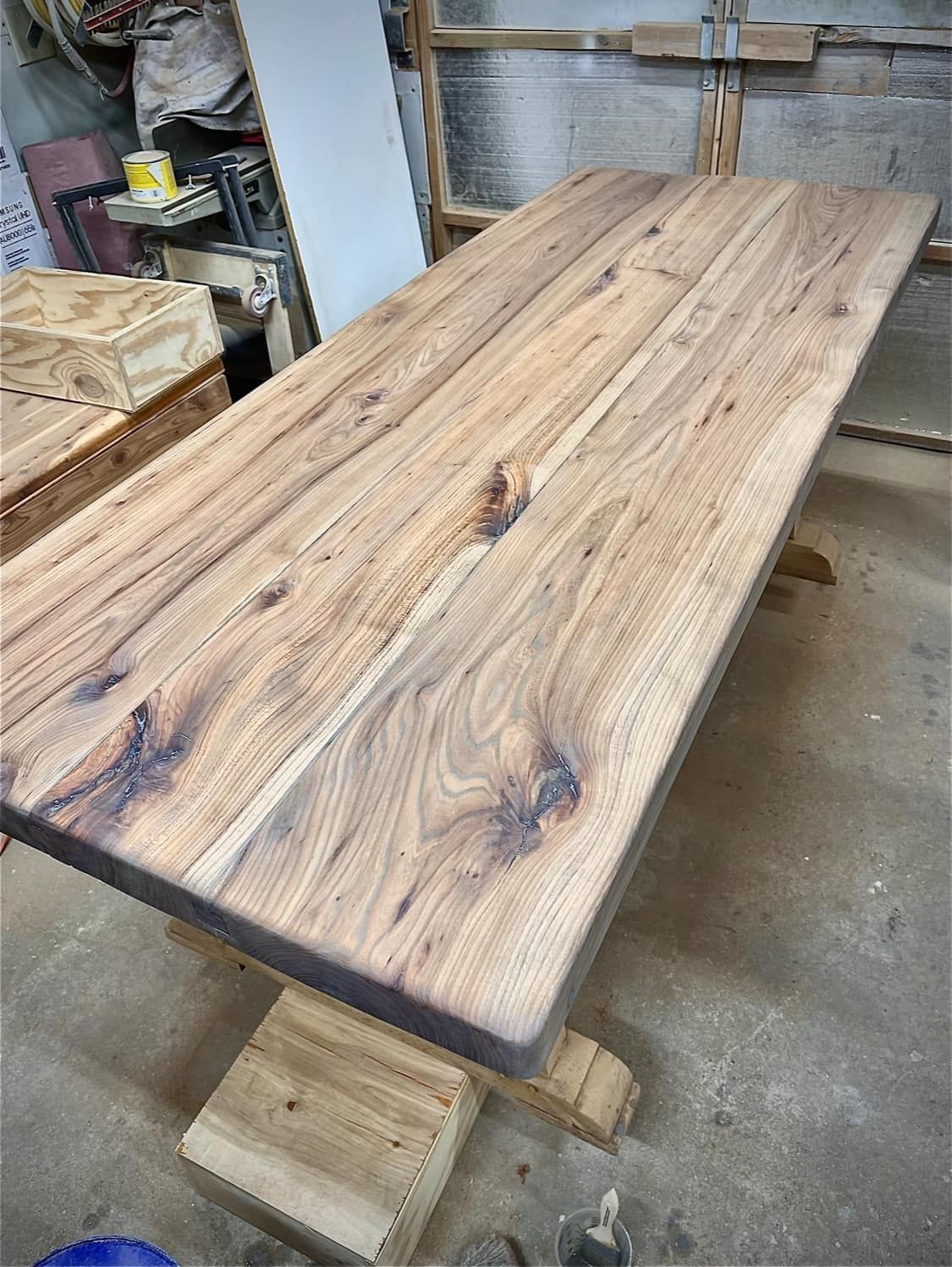 Wooden dining table with rustic, natural wood grain.