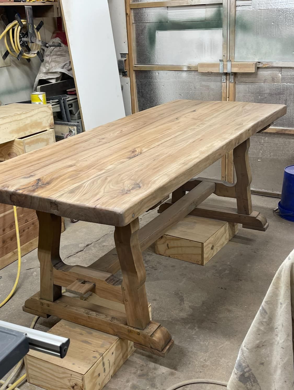 Wooden trestle table in a workshop setting.