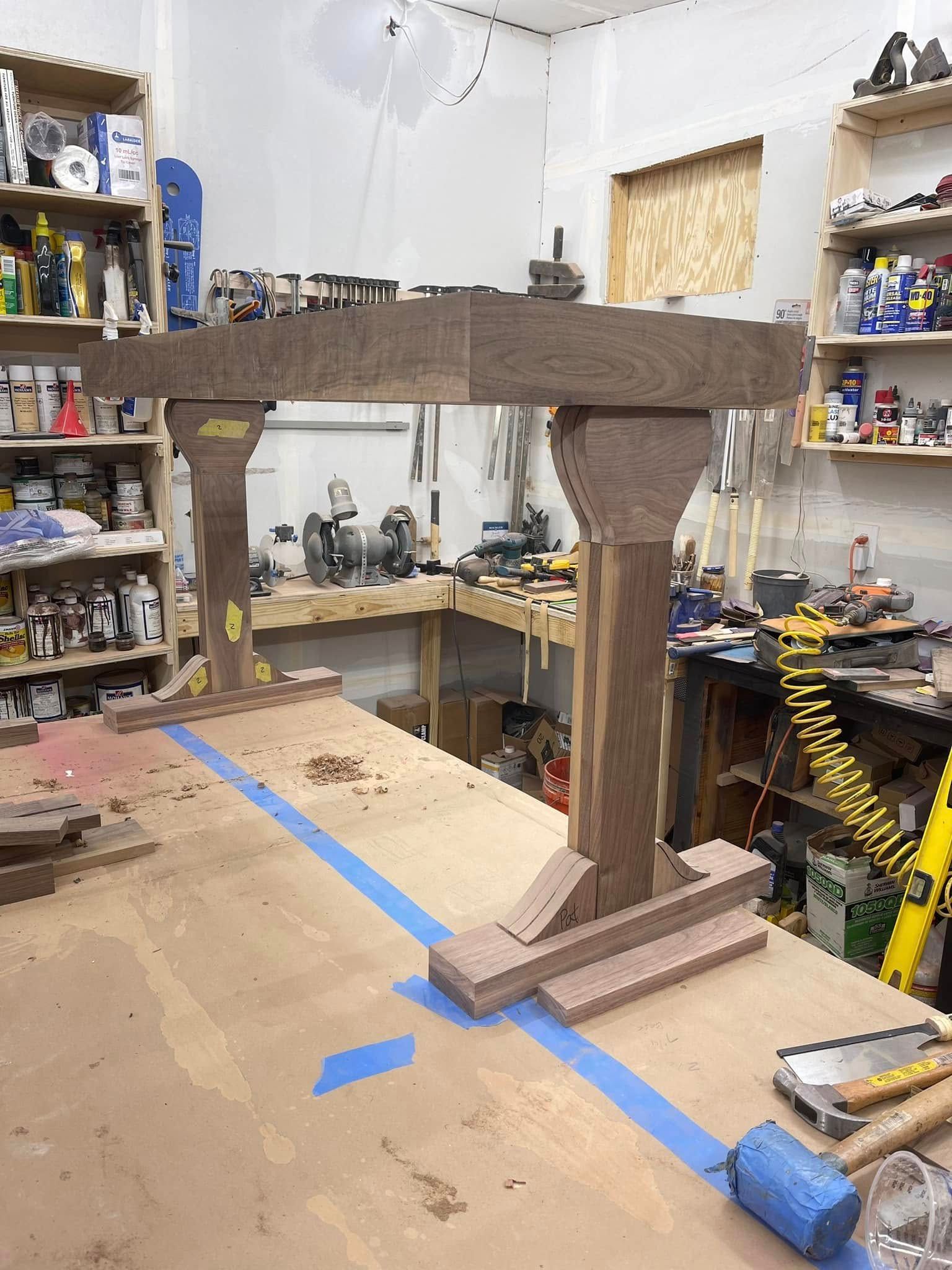 Wooden woodworking project with a table frame in a workshop.