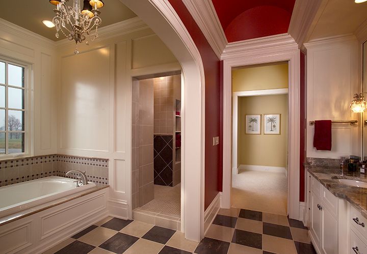 Bathroom with red and white walls, checkerboard floor, and a bathtub.