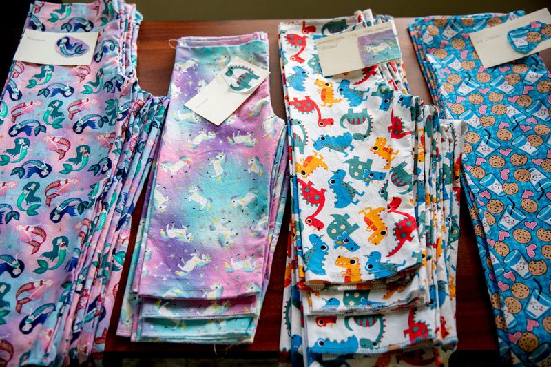 A table topped with a variety of colorful leggings
