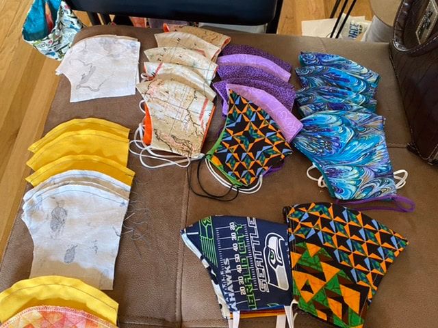 A table with a bunch of face masks on it