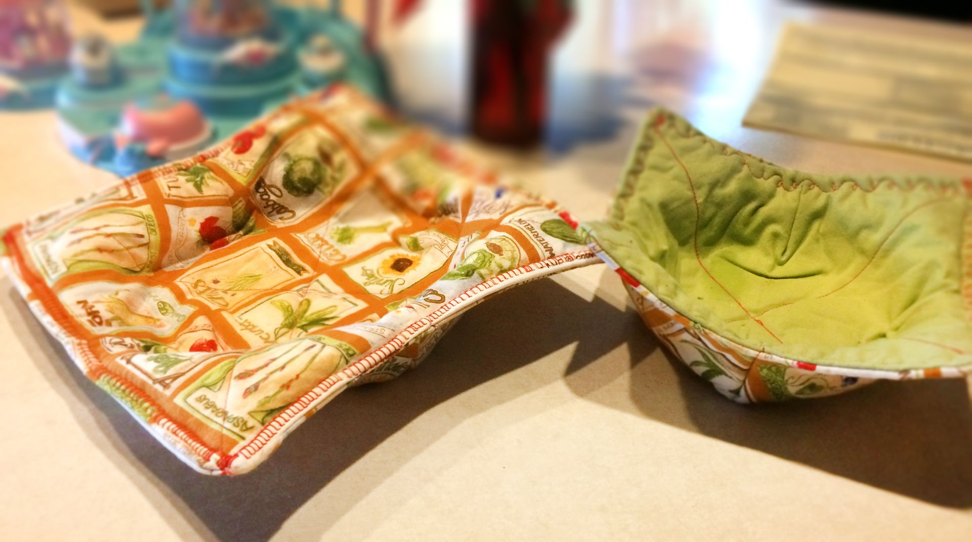Two colorful bowls are sitting on a table.