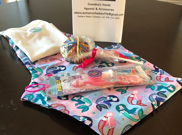 A toothbrush and a lollipop are sitting on a table.