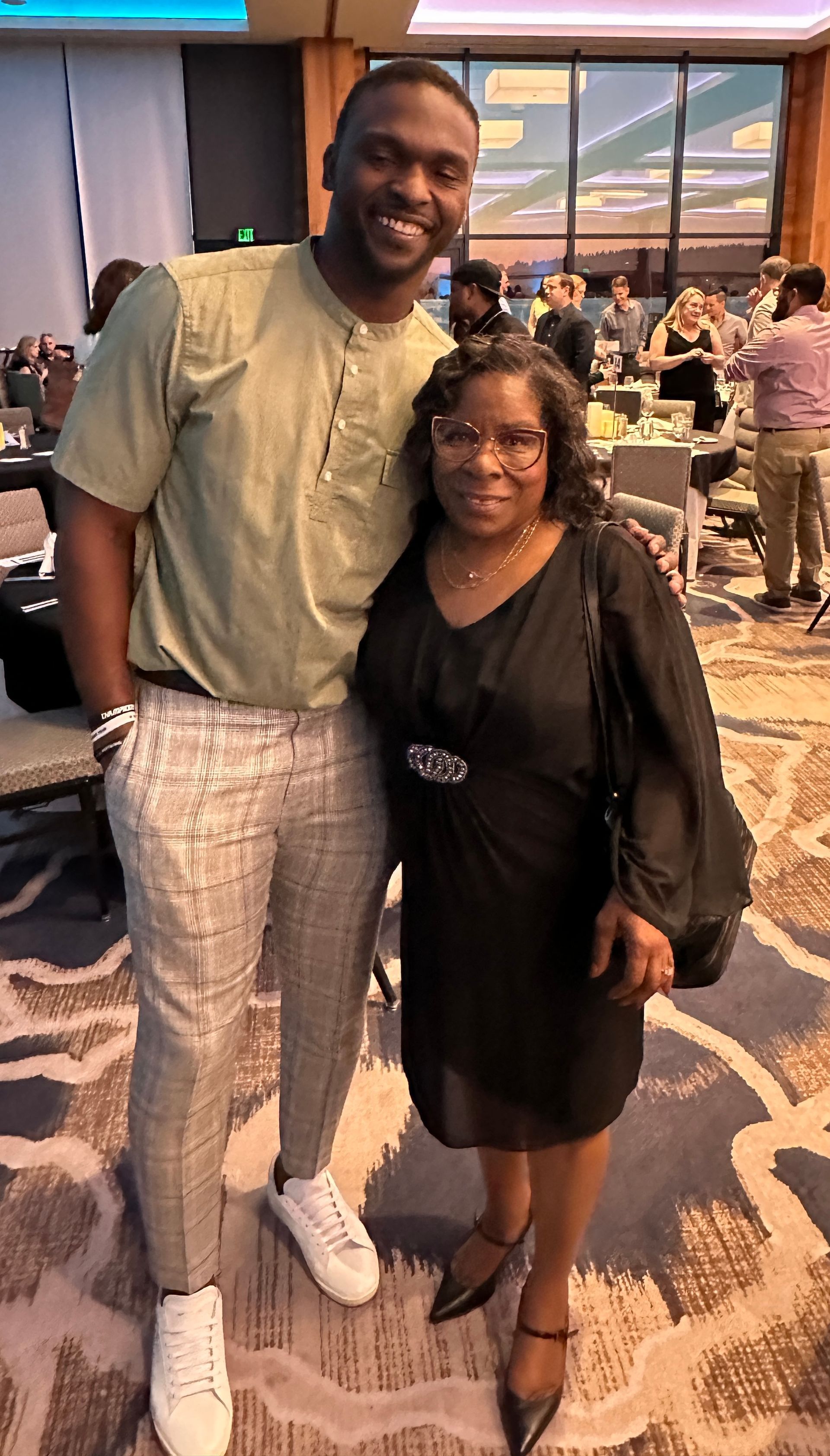 A man and a woman are posing for a picture in a room.