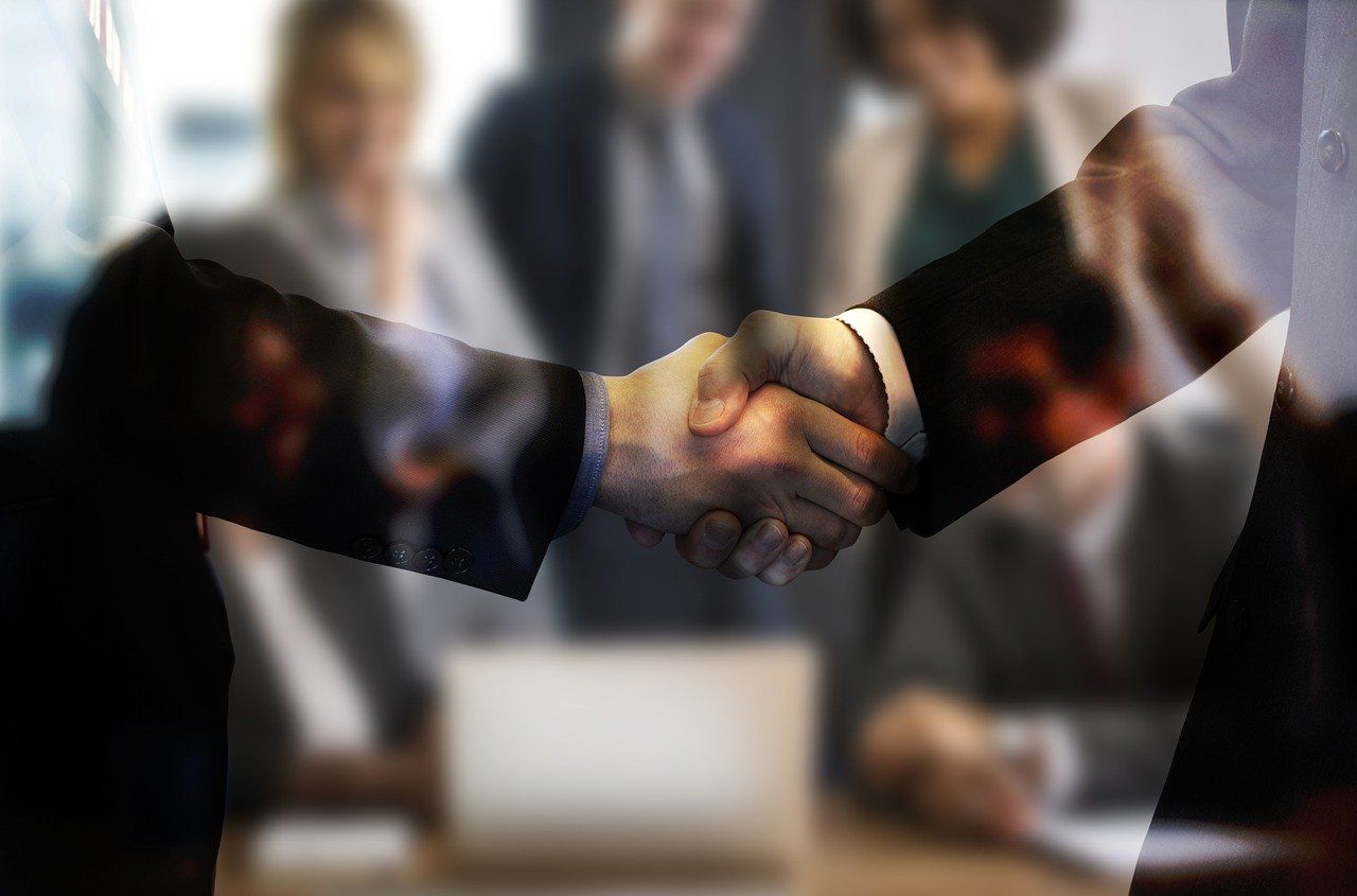 Business sales agreement handshake