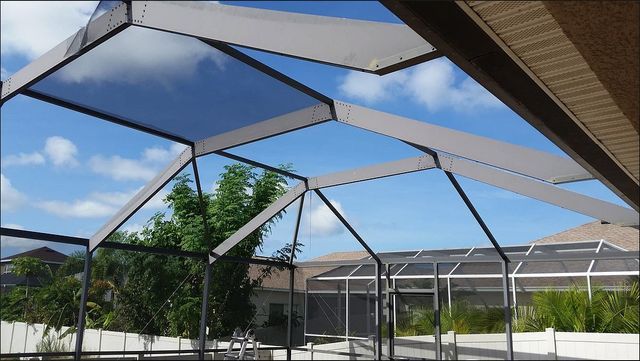 A screened in area with a blue sky in the background