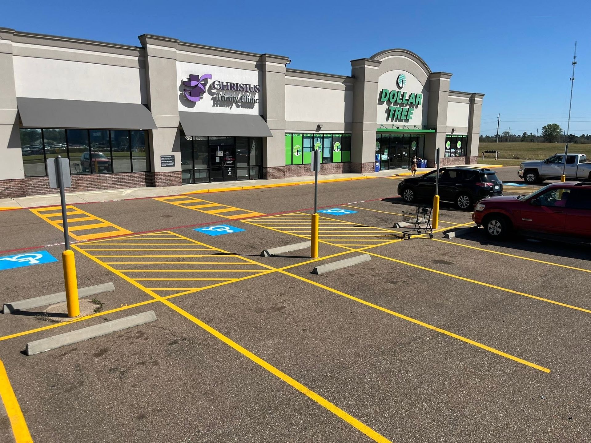 Accessible parking spaces in front of a strip mall on a sunny day