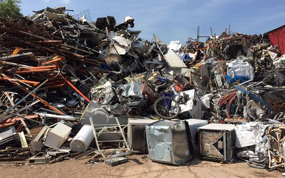 Pile of scrap metal against a clear blue sky.