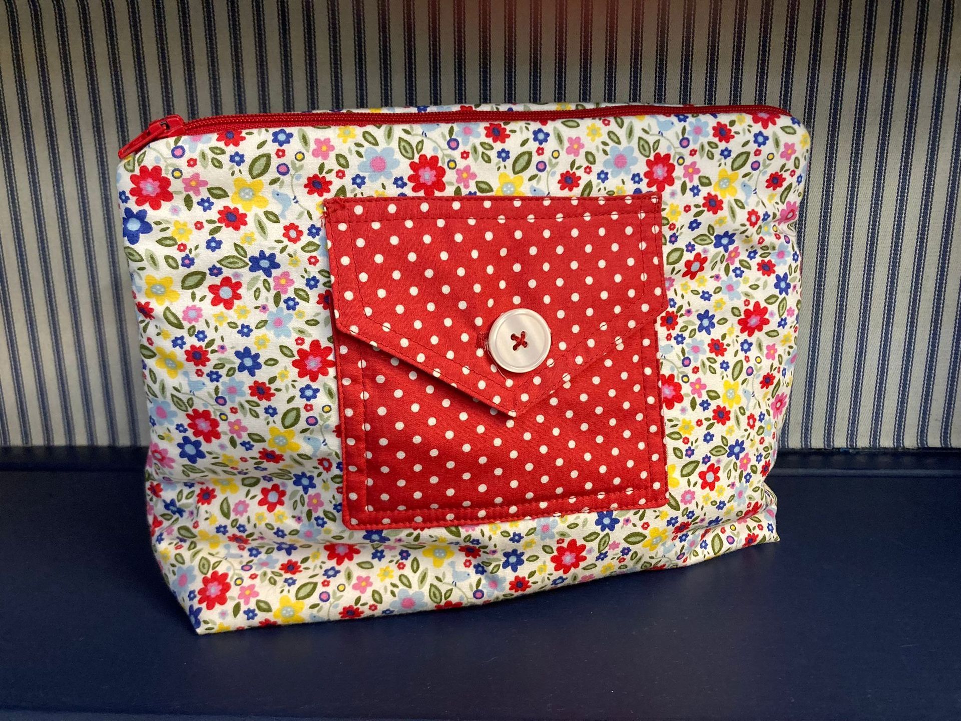 A colorful purse with a button on the front