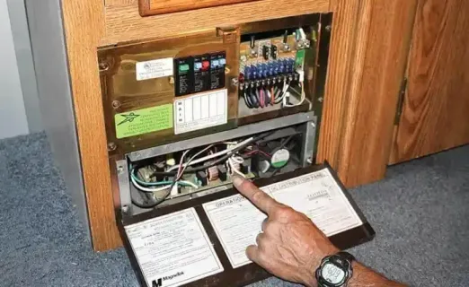 Car repairman wearing white uniform charging the car battery