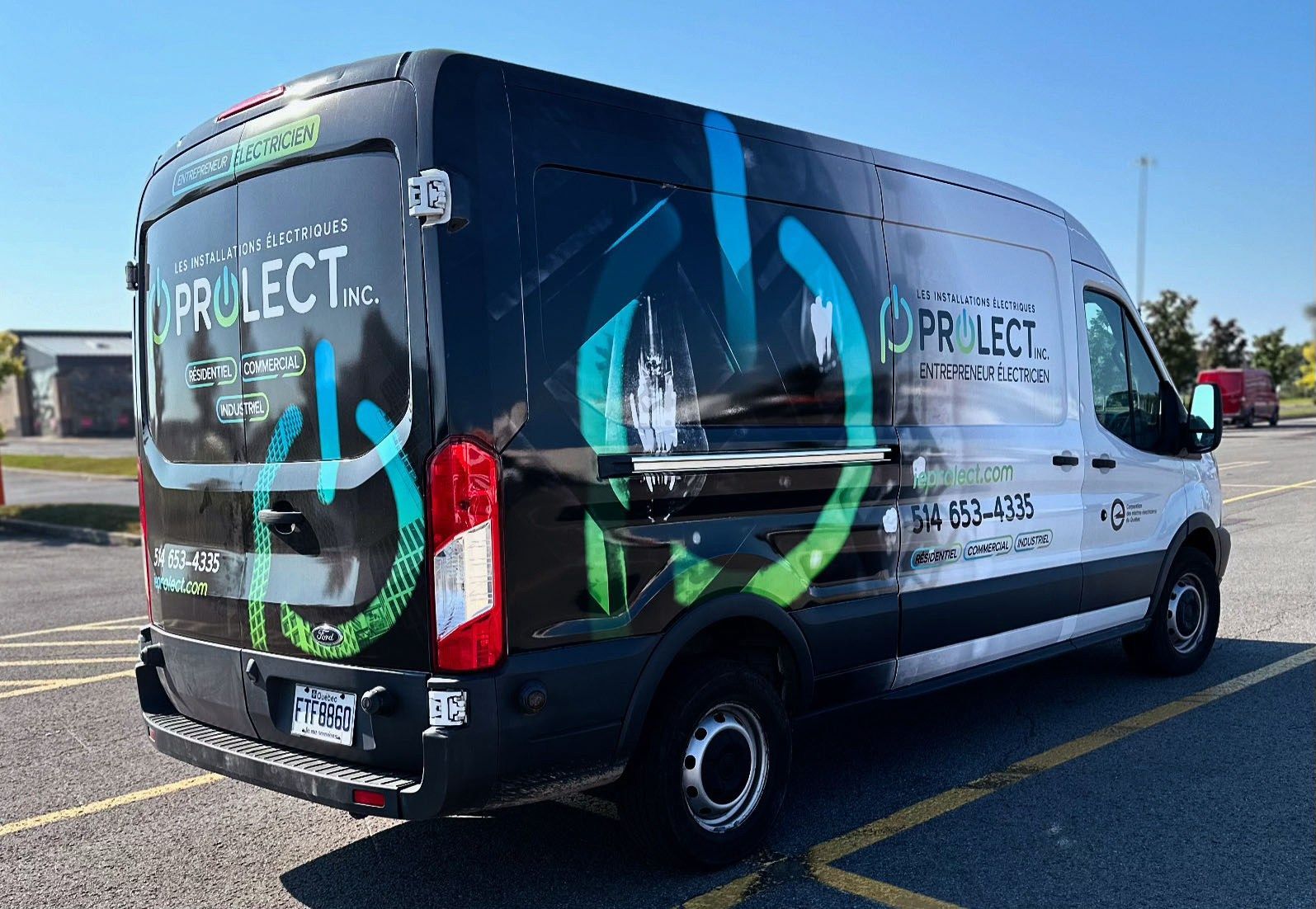 A black and white work van branded with