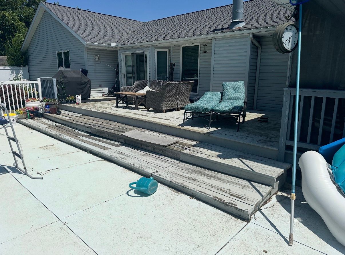 Back patio with pool, steps, lounge chairs, and a house exterior in bright sunlight