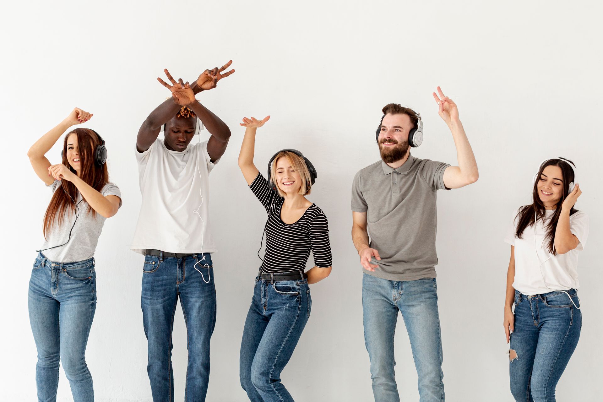 A group of young people are dancing and listening to music.