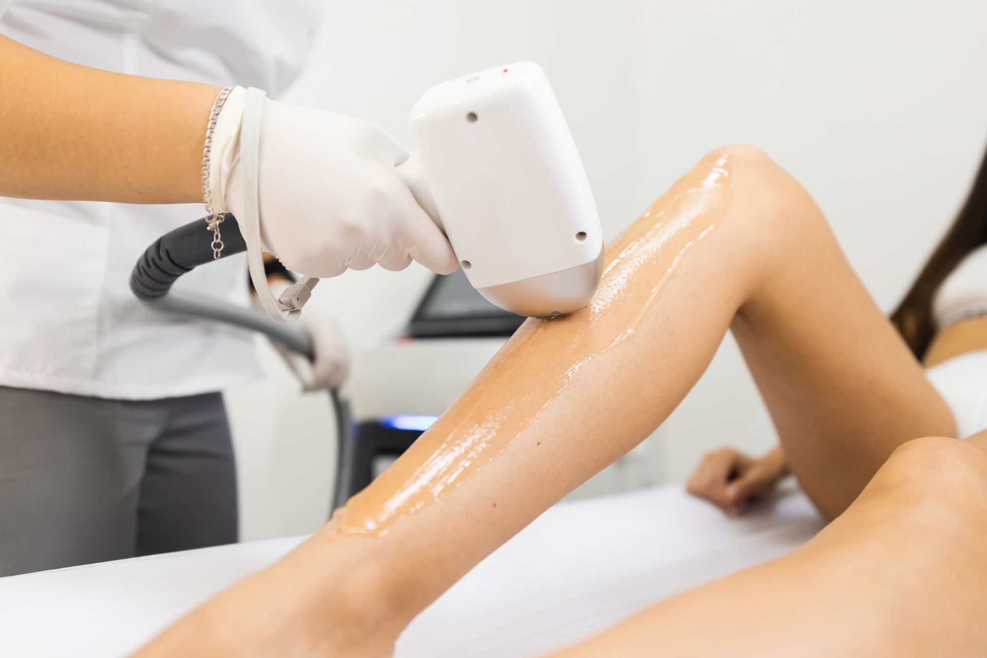 Person receiving laser hair removal on their leg.