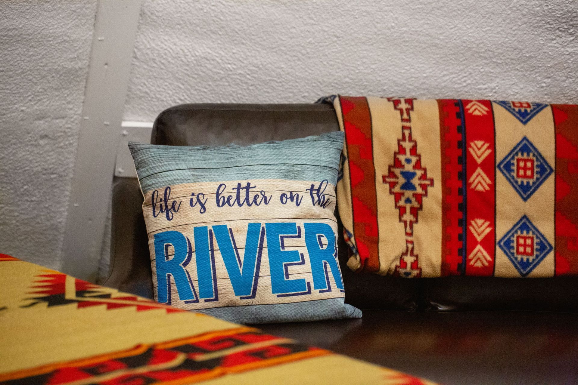 Couch with pillows; one reads 