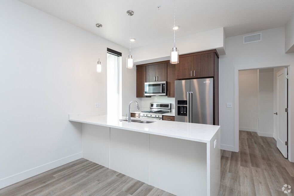 a kitchen with stainless steel appliances and a large island .