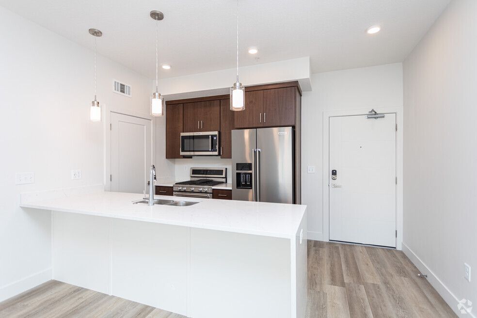 a kitchen with stainless steel appliances and a large island .