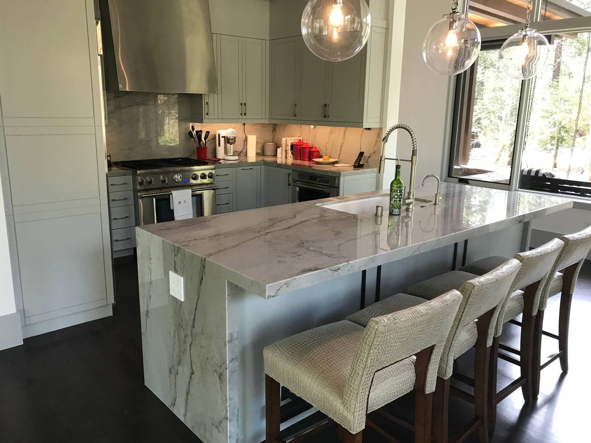 A kitchen with a large island and stools