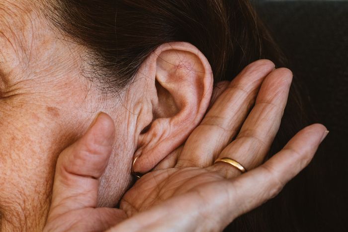 Senior Woman Holding Her Ear — Sewell, NJ — Hearing Hut LLC Senior Woman Holding Her Ear — Sewell, NJ — Hearing Hut LLC