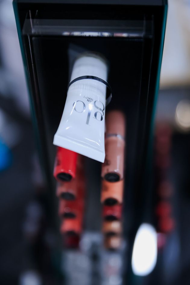 Close-up of a white and red electric toothbrush head inside a black charging dock