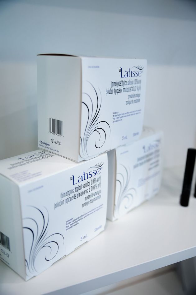 White product boxes with black floral designs stacked on a shelf