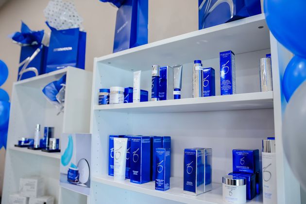 White shelves displaying assorted blue-and-white product boxes and bottles in a store display