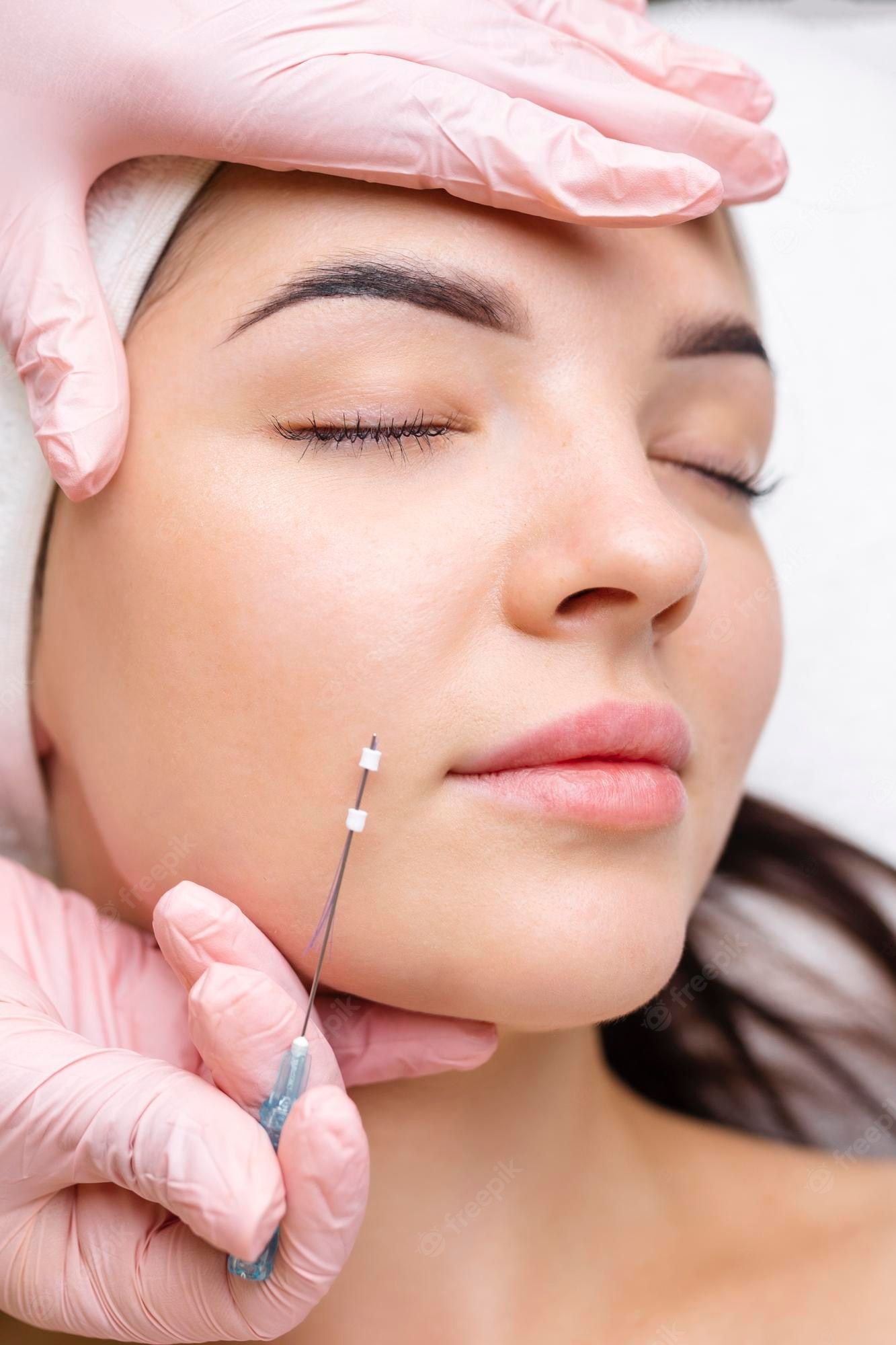 a woman is getting a botox injection in her face