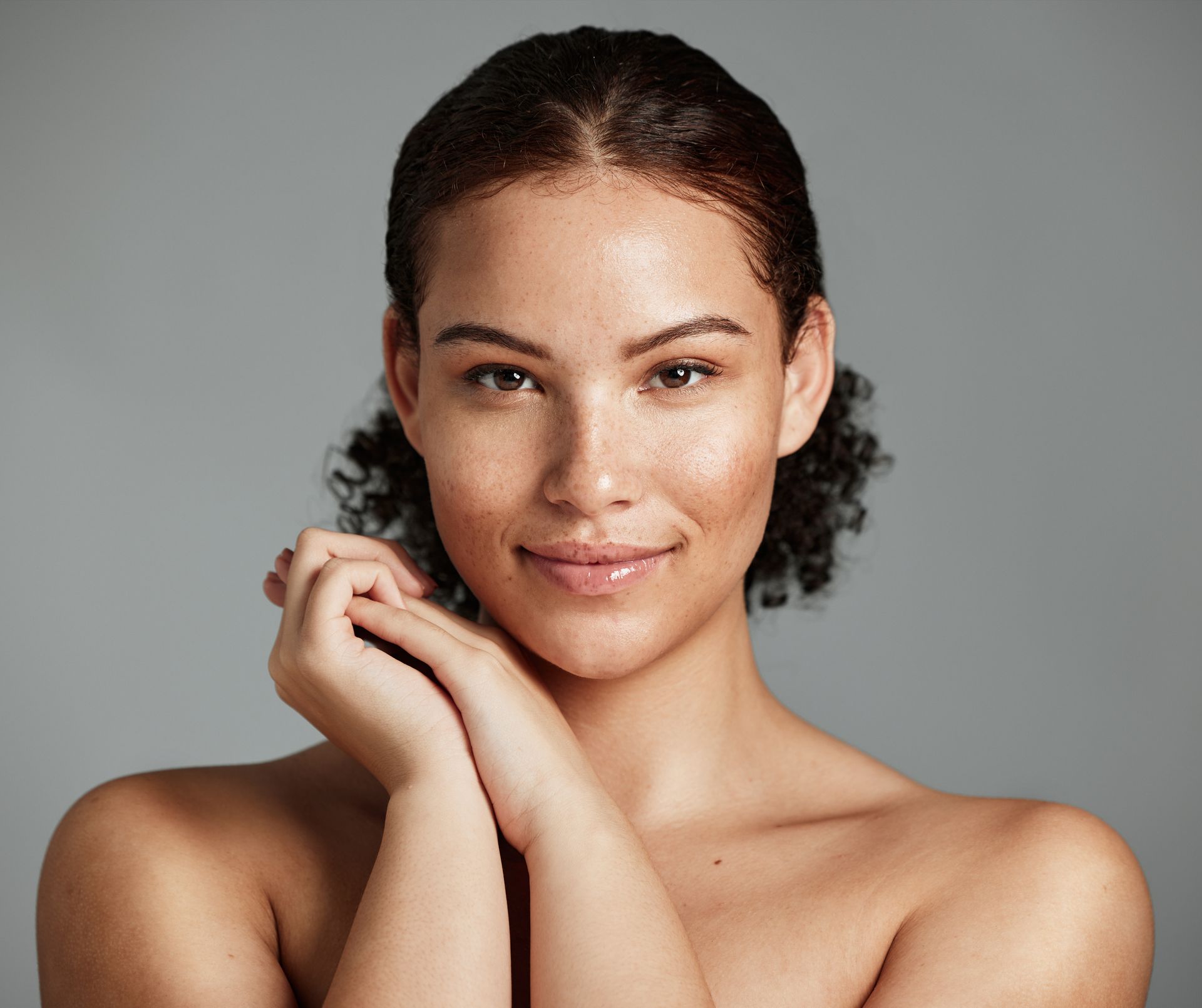 beautiful woman holding hands together and smiling
