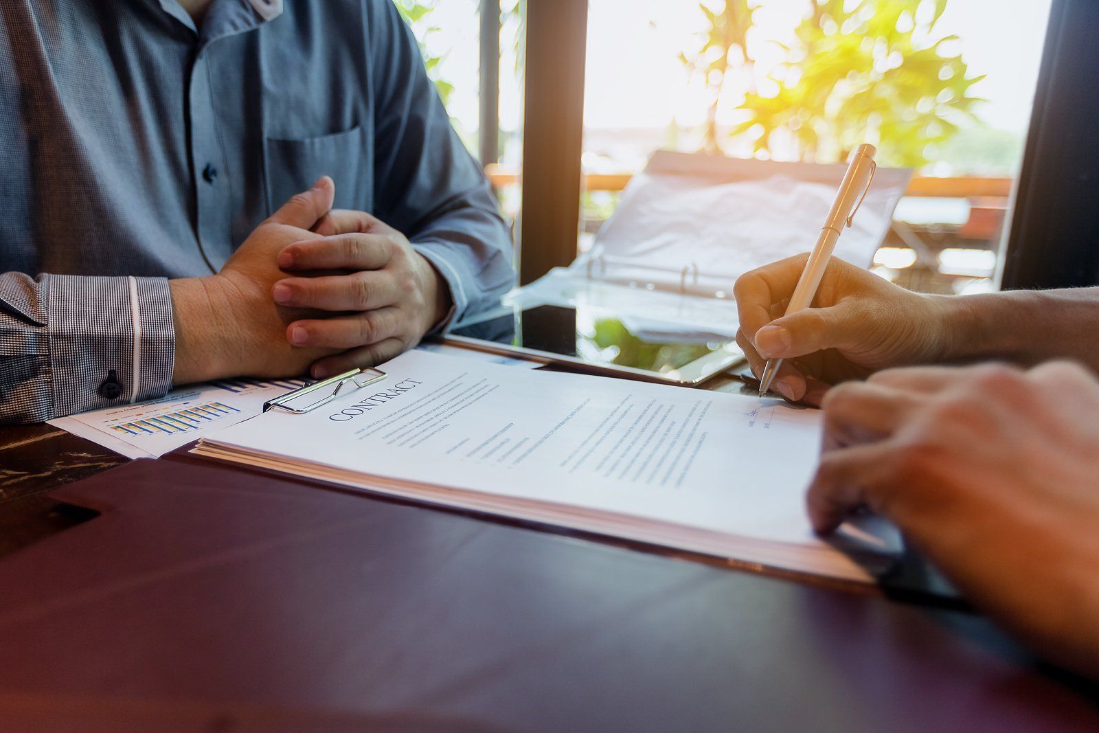 Customer of Car Loans Adelaide signing finance contract on new machinery