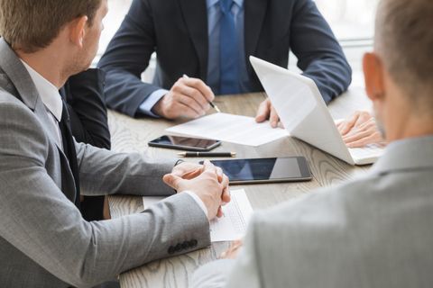 Finance Broker showing personal loan document to young business owner in adelaide