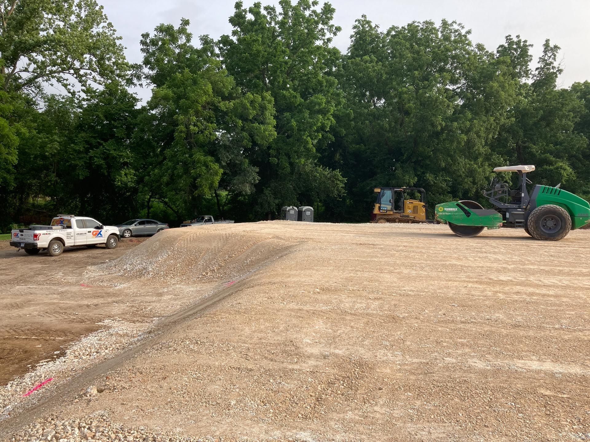 A large pile of dirt is sitting in the middle of a construction site.