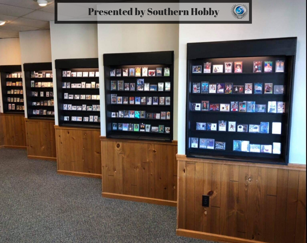 Display cases with trading cards, Southern Hobby, in a store setting, with wood paneling.