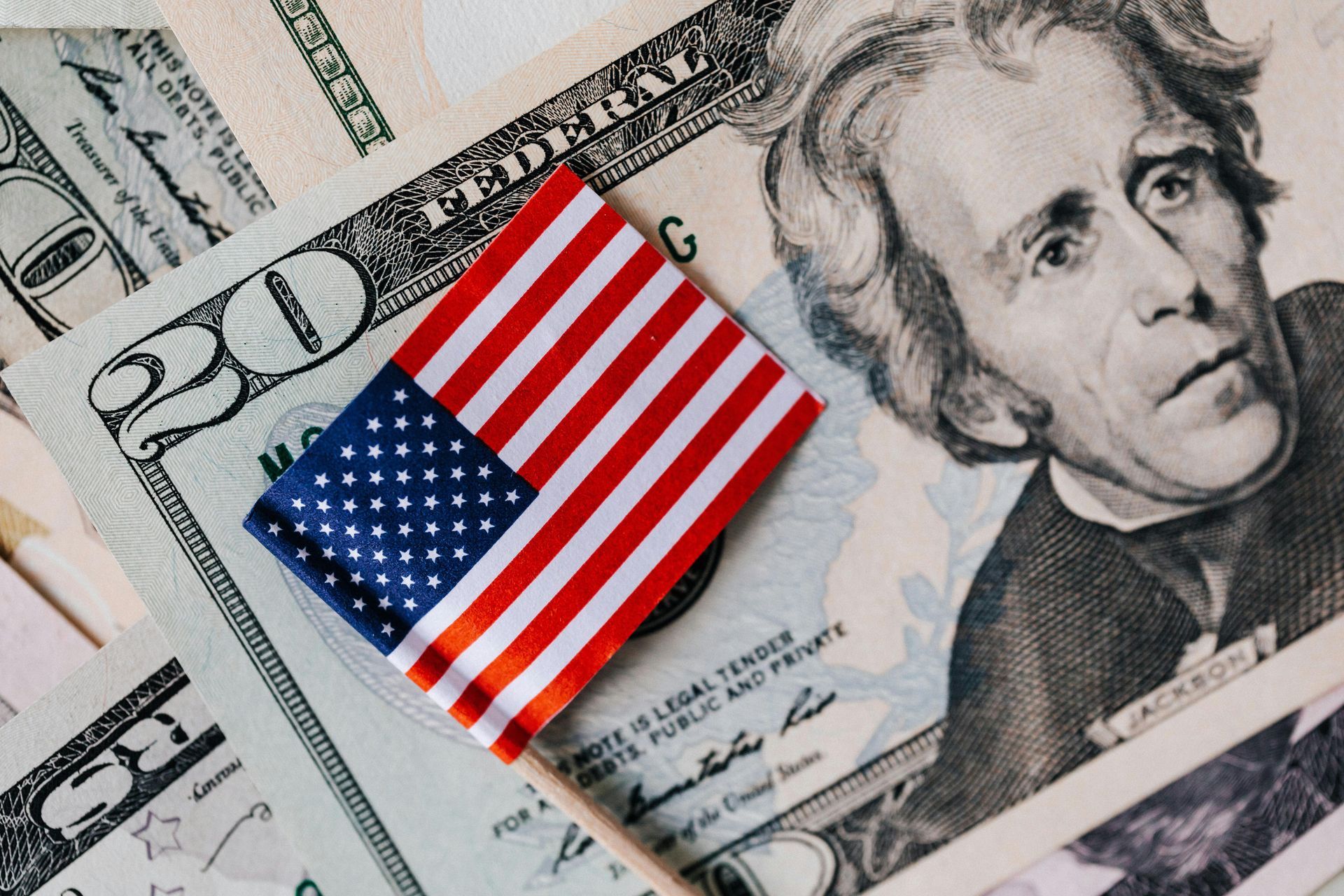 American flag on $20 bills, depicting Andrew Jackson, financial concept.