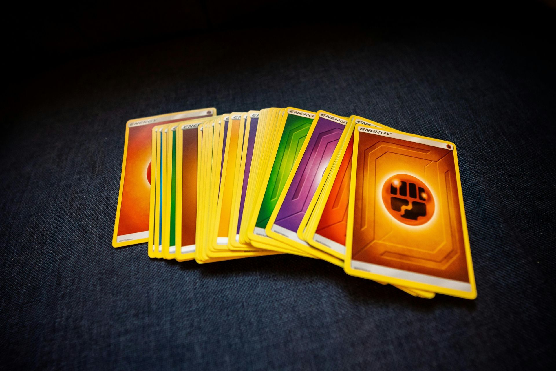 Fan of colorful trading cards on a dark surface