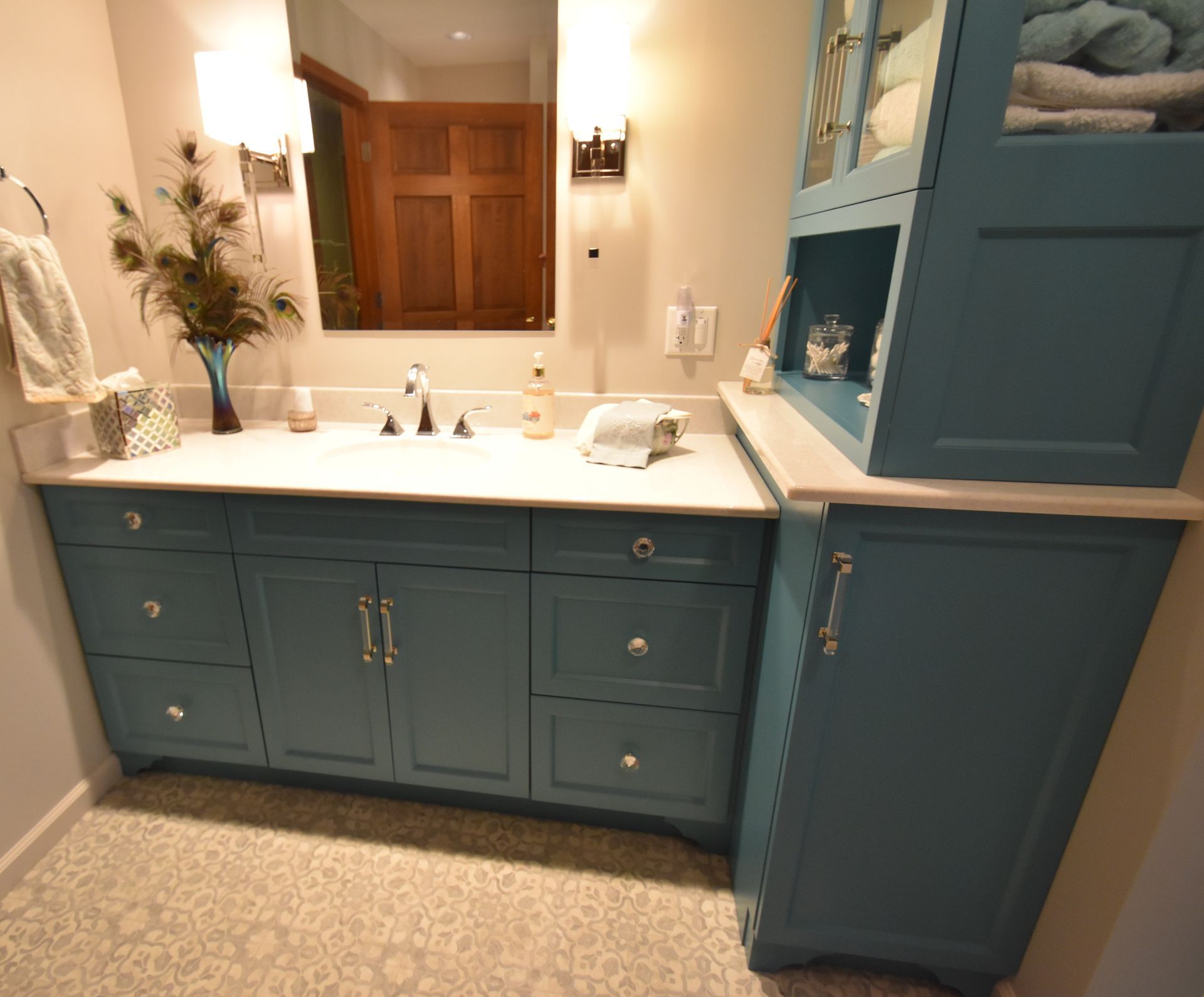 Blue bathroom vanity with white countertop, sink, mirror, and wood window shutters