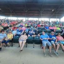 A large group of people are sitting in a stadium.