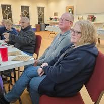 A group of people are sitting at tables in a room.