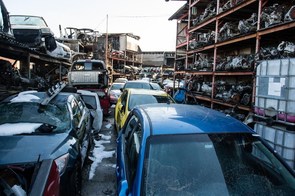 A Bunch Of Cars Are Sitting On Top Of Each Other In A Junkyard — Caloundra Scrap Metal in Maroochydore, QLD