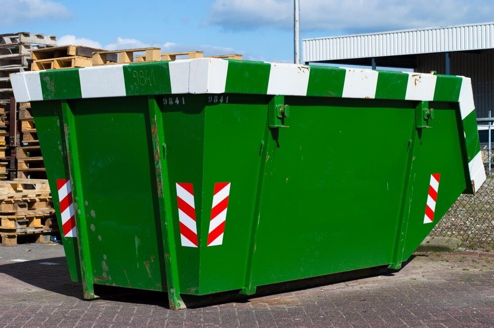 A Green Dumpster With Red And White Arrows On It — Caloundra Scrap Metal in Caloundra, QLD