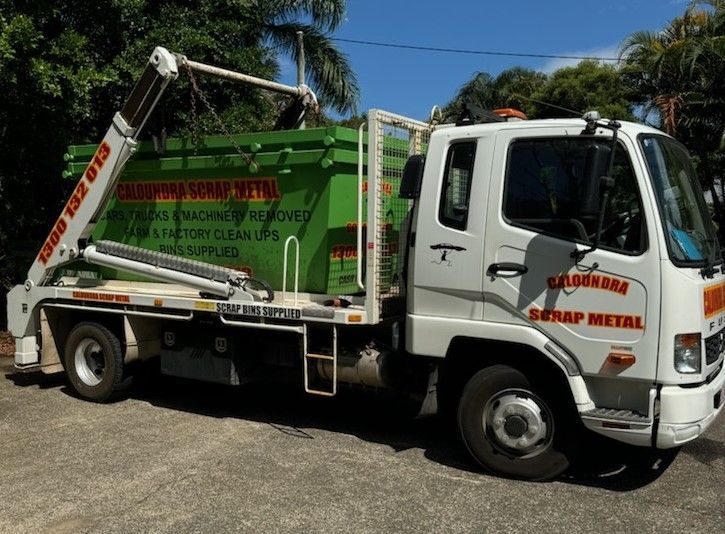 A Blue Dumpster Is Parked On A Brick Driveway — Caloundra Scrap Metal in Landsborough, QLD